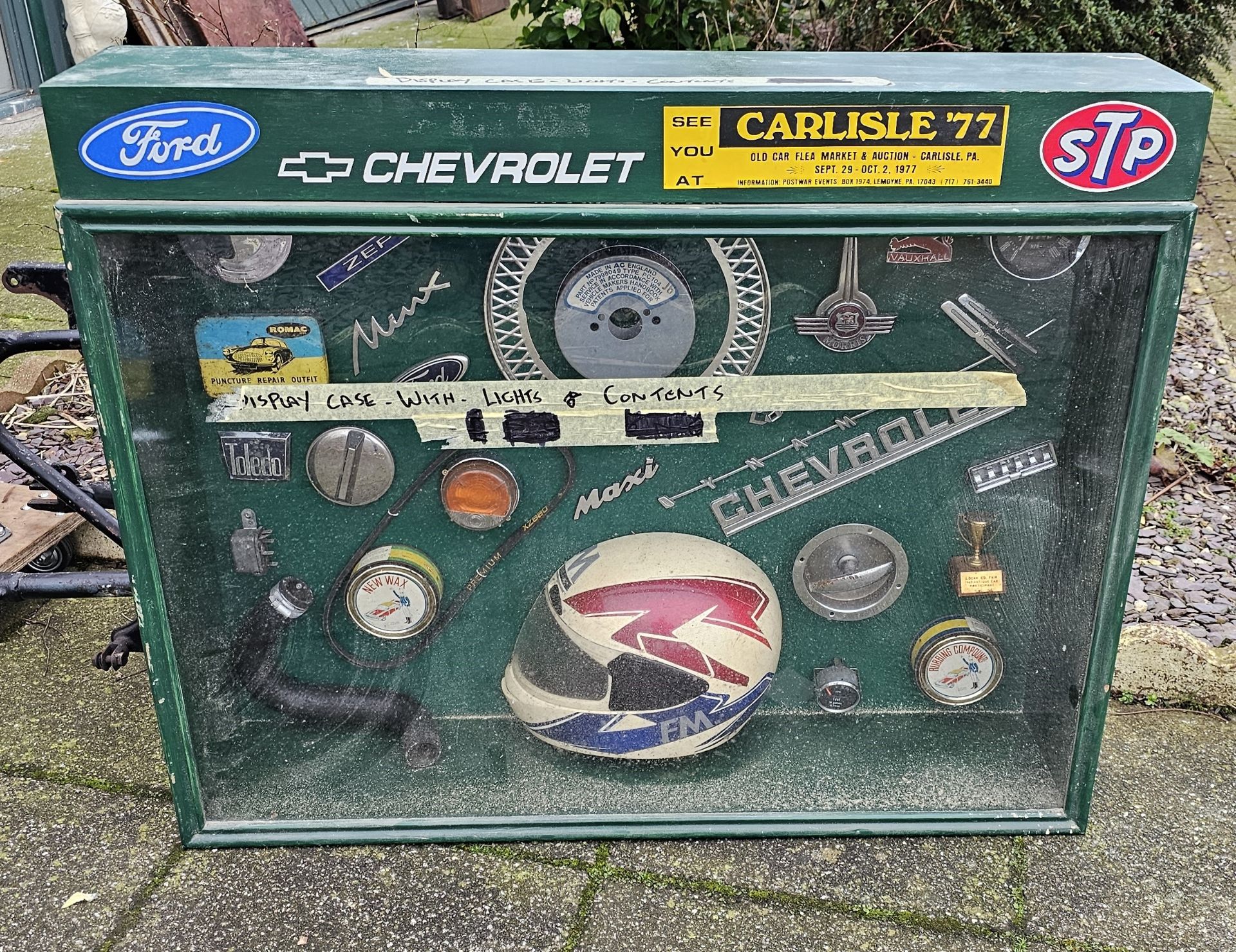 A glazed cabinet with mounted automobilia