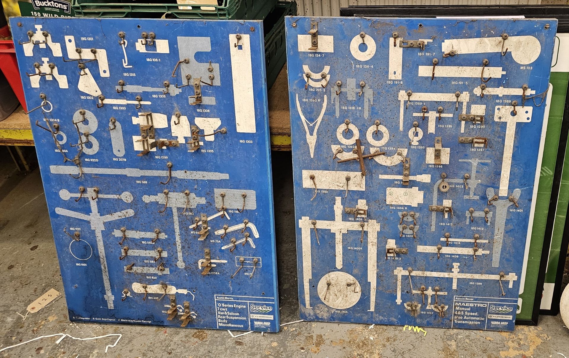 An Austin Rover metal Maestro wall tool display board and a another for an O series engine.