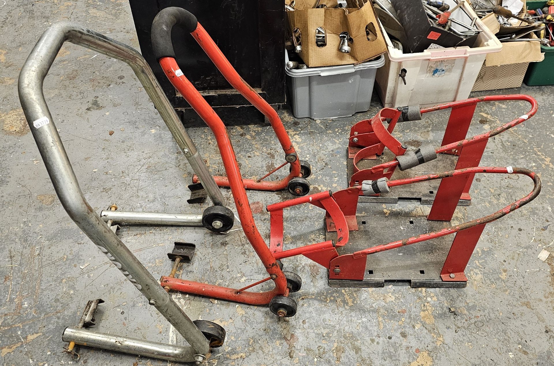 Two motorcycle paddock stands and two wheel chocks