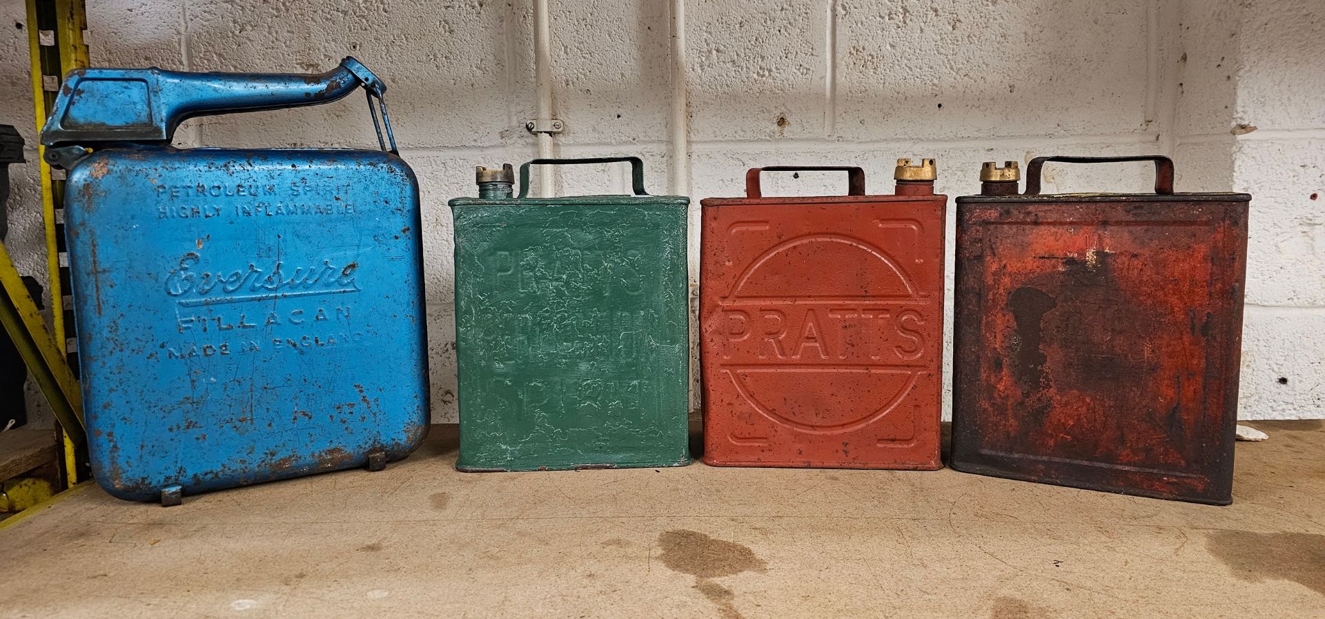 Two Pratts Motor Spirit two gallon petrol cans, with caps, an unmarked example and an Eversure can