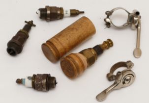 A veteran Darop brass spark plug, in wooden case, three other vintage spark plugs and and two levers