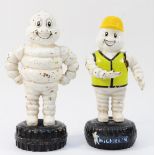 A cast iron and painted Bibendum/Michelin Man money box, 22cm and another with moving arms, 21.