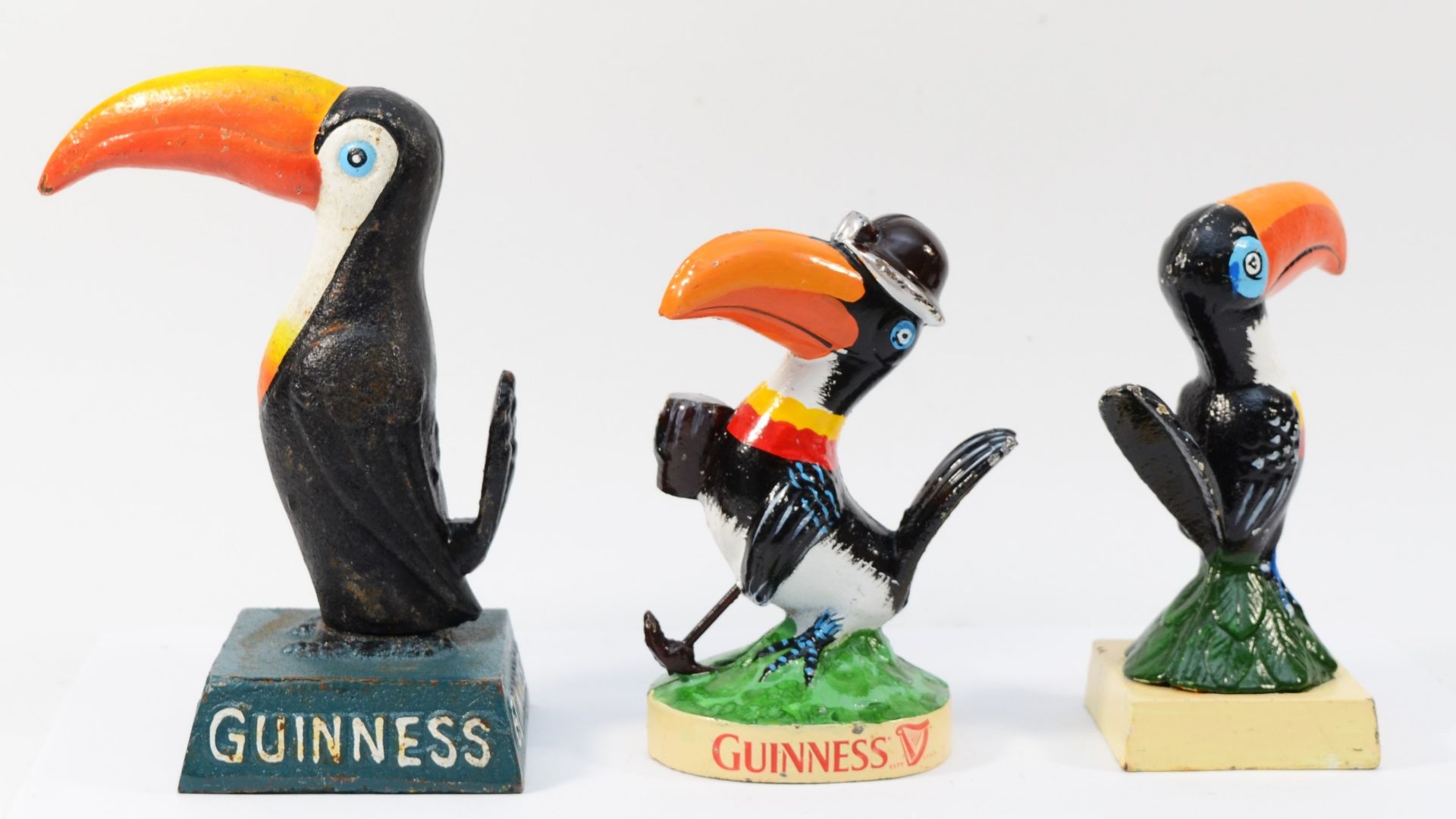 A cast iron and painted Guinness toucan, 19.5cm, and two smaller examples, 17cm (3). - Image 2 of 2