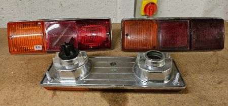 Two Lucas L782 RH rear light units, NOS, and a used example. As fitted to Lotus 7 and Aston Martin