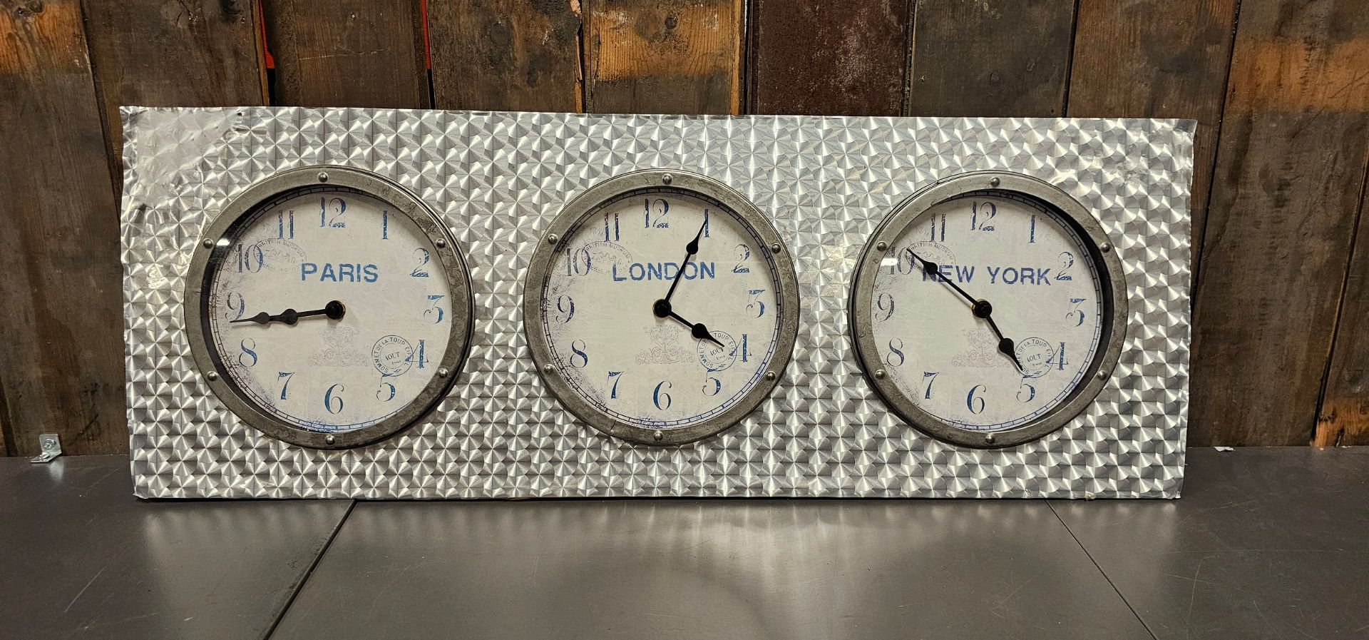 A time zone triple clock panel, London, New York, Paris, quartz movements, simulated turned alloy