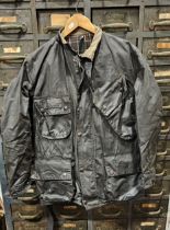 A Barbour International waxed jacket, size 40 with matching trousers, size unknown, probably 36