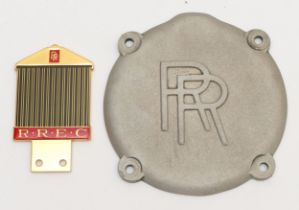 A gold plated and enamel RREC grill badge and an alloy RR cover plate, part no G50143 (2)