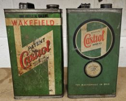 Two Castrol one gallon oil cans with caps.