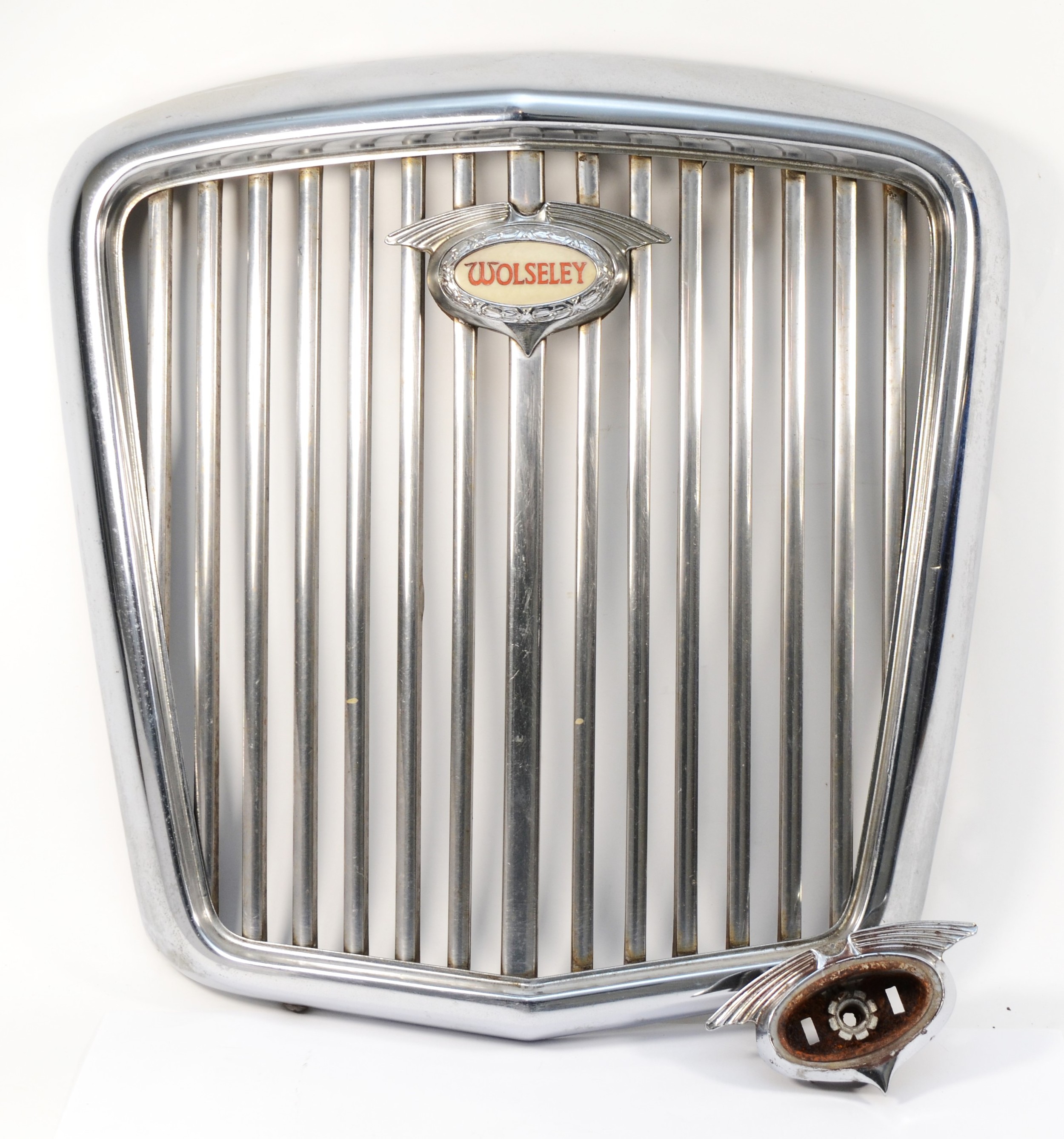 A chrome Wolsey grill with illuminated badge, together with a spare badge surround