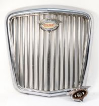 A chrome Wolsey grill with illuminated badge, together with a spare badge surround