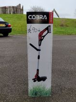 A Cobra GT3024V cordless 30cm wide lawn edger, unused in box.