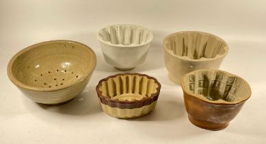 Four mid 20th century Denby glazed stoneware jelly moulds with a stoneware sieve.