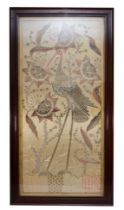 A 20th century silk stump work style embroidery of a standing crane amongst flowers, 95x46cm,