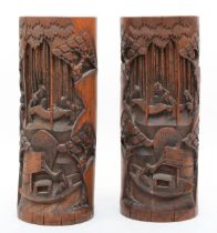 A pair of early 20th century Chinese bamboo carved brush pots, with scenic decoration, 28cm.