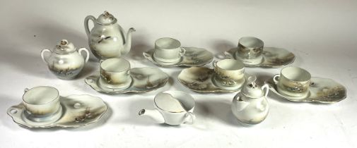An early 20th century Japanese eggshell porcelain tea service, comprising six cup & saucers, teapot,