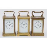 Three 20th century brass cased carriage clocks, each with white dials and black Roman numeral and