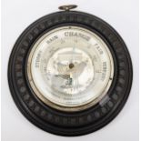 A late 19th/early 20th century ebonised cased circular aneroid barometer, the white dial retailed by
