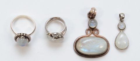 Two silver moonstone rings and two silver moonstone drop pendants, largest 50 x 33mm, 34gm.