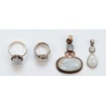 Two silver moonstone rings and two silver moonstone drop pendants, largest 50 x 33mm, 34gm.