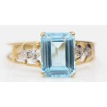 A 9k gold blue topaz dress ring, with eight cut diamond shoulders, O-P, 1.7gm.