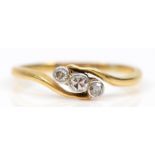 An 18ct gold three stone eight cut diamond dress ring, L-M, 1.7gm.