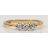 An 18ct gold three stone old cut diamond dress ring, O, 2.2gm.