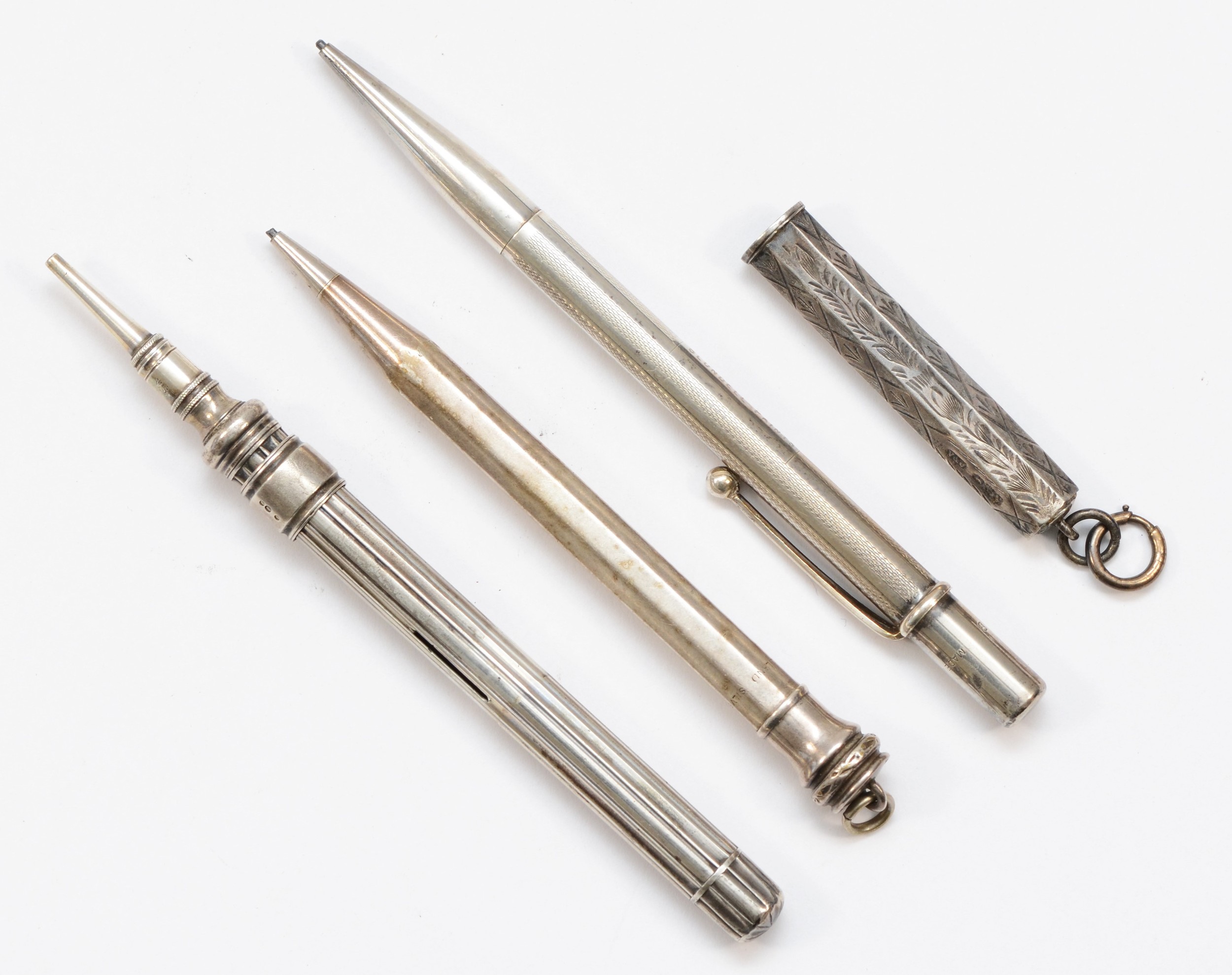 Three silver bodied pencils to include a Eversharp example, and a George V silver pencil holder,