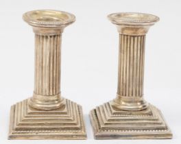 A pair of Victorian silver doric column candle sticks, by Henry Williamson, Birmingham 1899, on