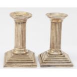 A pair of Victorian silver doric column candle sticks, by Henry Williamson, Birmingham 1899, on