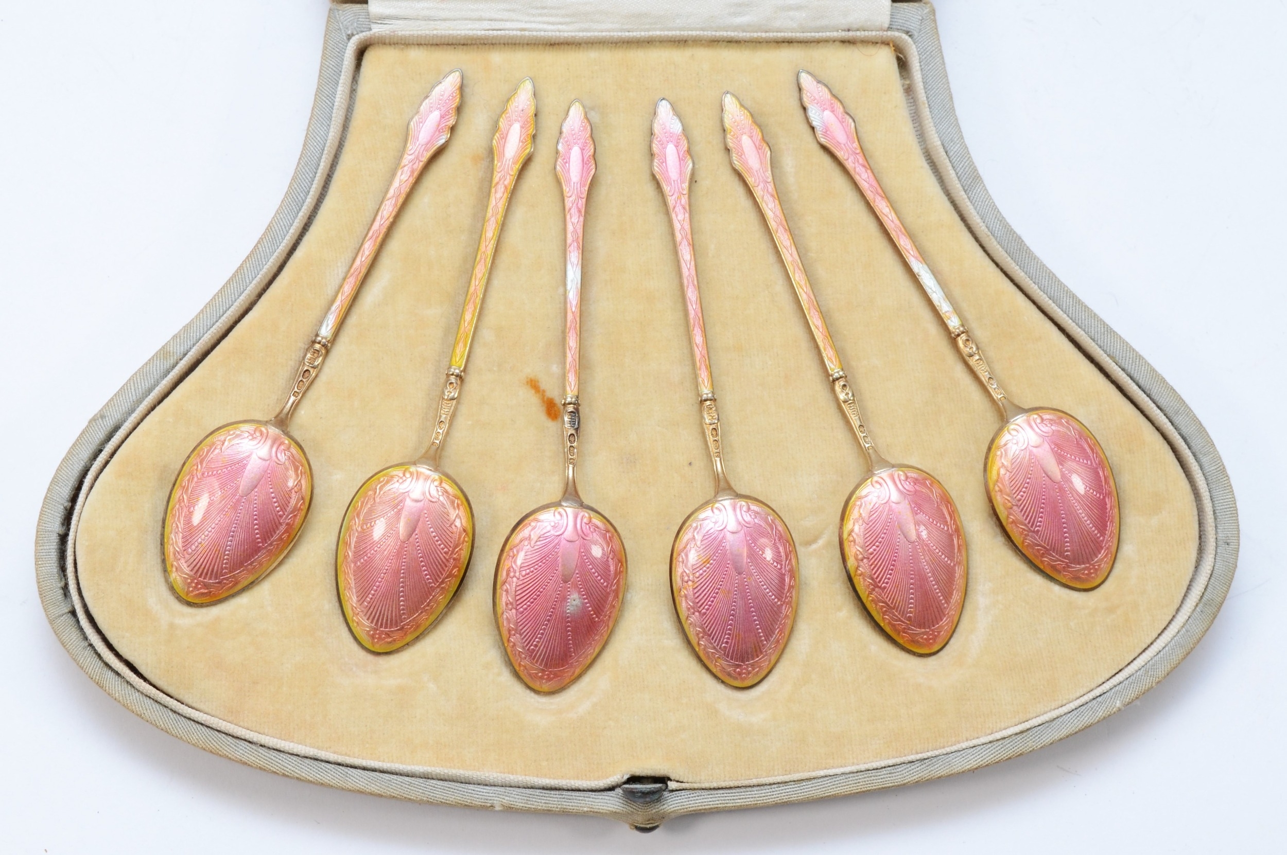 A set of Art Deco silver gilt and pink gouache enamel tea spoons, London import 1920, 65gm, cased. - Image 2 of 2