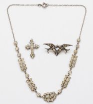 A 900 silver swallow brooch set with rhinestones, 41 x 18mm, a silver paste stone cross and a