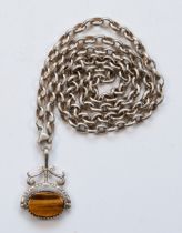 A vintage silver tigers eye and onyx swivel fob, on a silver chain, 35 x 25mm, 46gm.
