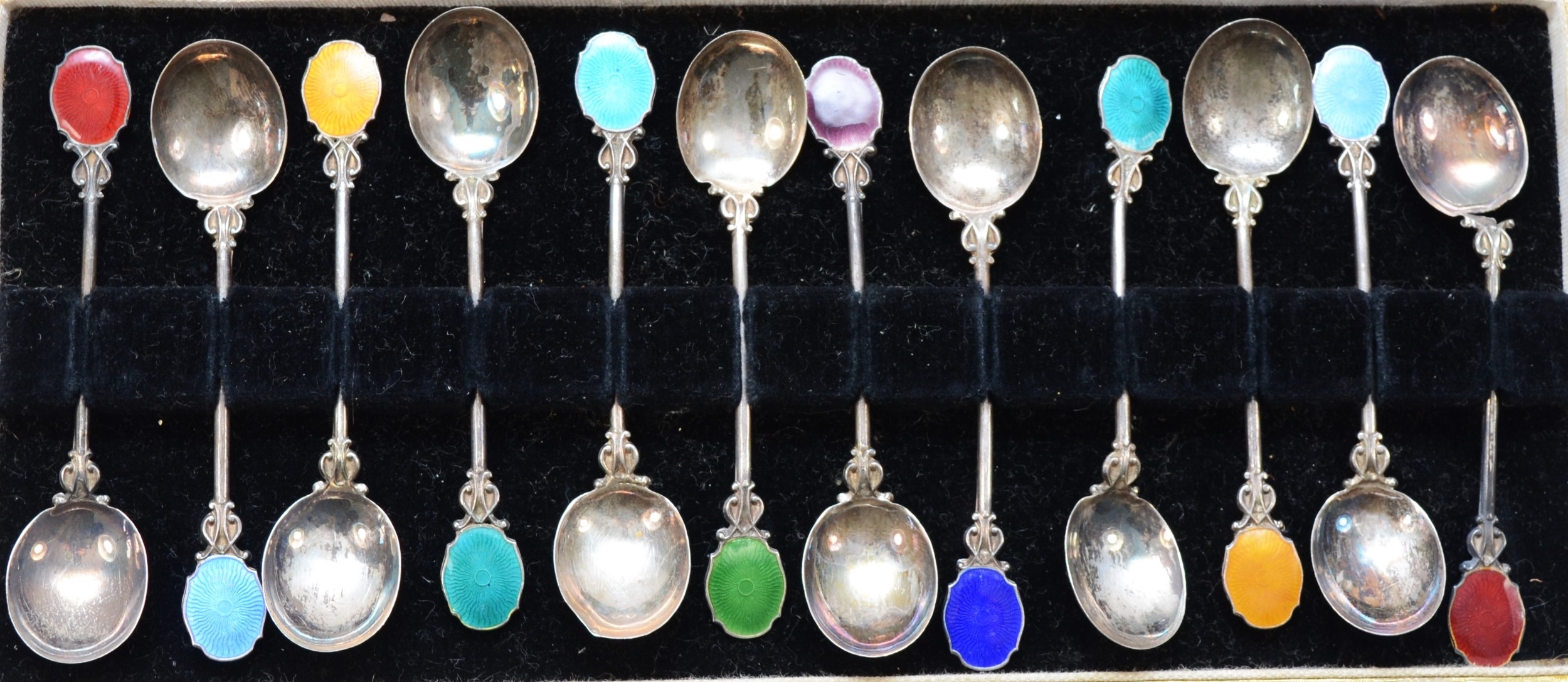 A set of twelve early 20th century continental silver and enamel tea spoons, cased, 60gm. - Image 2 of 2