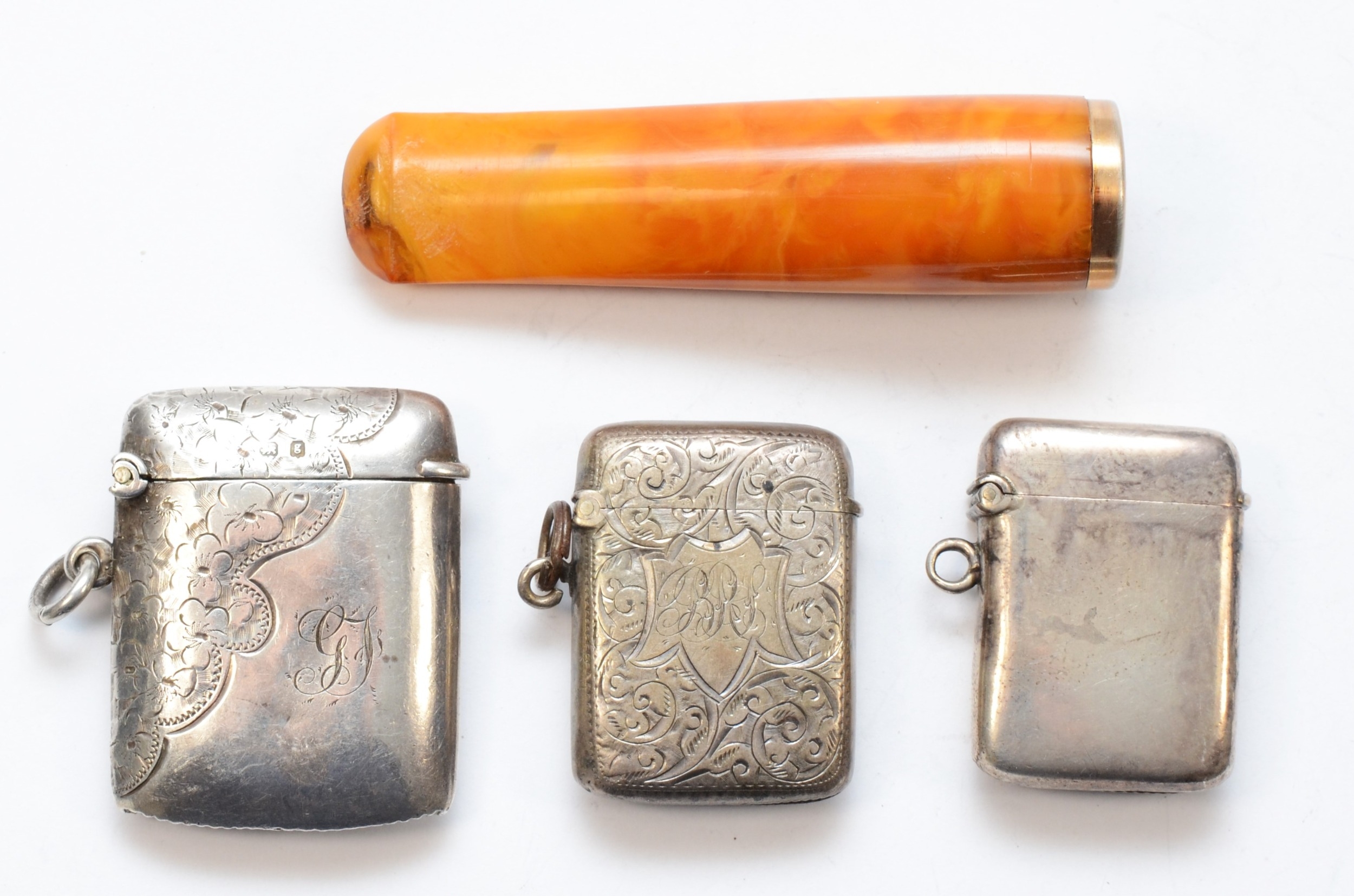 Three silver rectangular vesta cases, Birmingham 1896, 1903, 1906, 53gm, together with a German