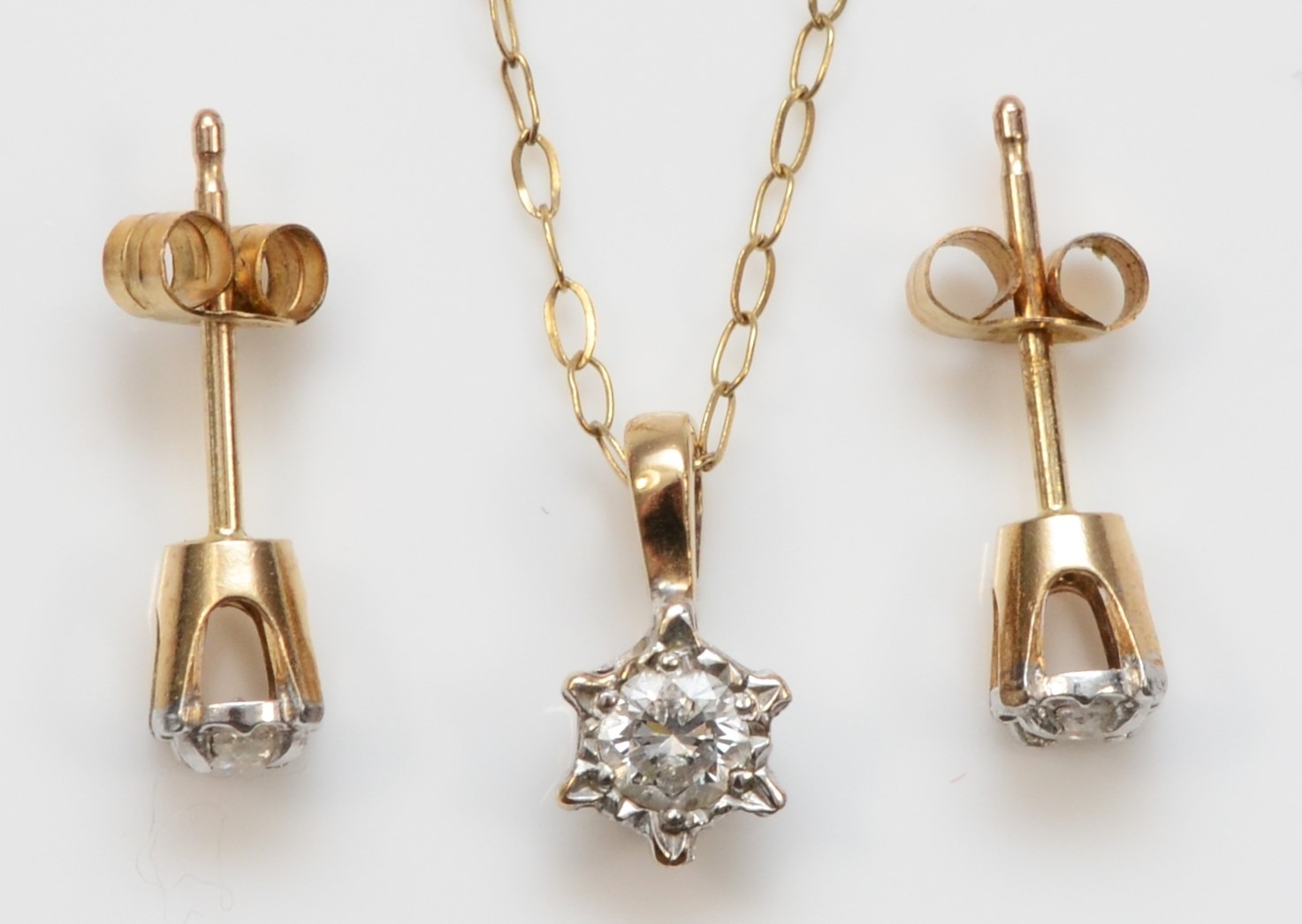 A 9ct gold brilliant cut diamond pendant, on 375 gold chain, together with a pair of 10k gold