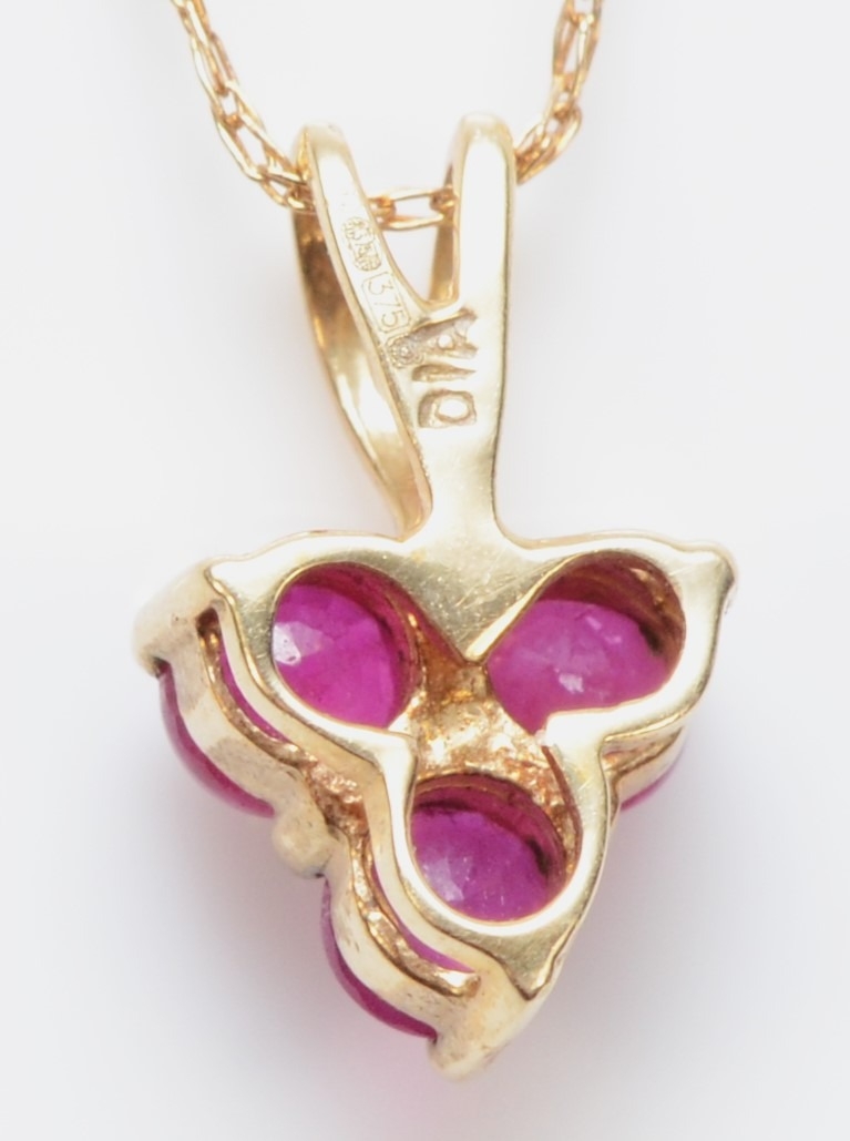 A 9ct gold ruby and eight cut diamond pendant, on a 375 gold chain, 11mm, .8gm. - Image 2 of 2