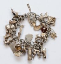 A silver heart padlock clasp charm bracelet with charms, to include a ball and claw example, 87gm.