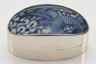 A Siam sterling silver oval pot, with ceramic blue and white glazed lid, 6.5 x 3 x 3.3cm.