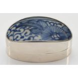 A Siam sterling silver oval pot, with ceramic blue and white glazed lid, 6.5 x 3 x 3.3cm.