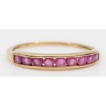 A 9ct gold channel set pink sapphire dress ring, S-T, 1.4gm.