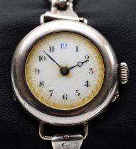 An early 20th century silver ladies wrist watch, by Stockwell & Co, 1916, the enamel dial set with