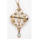 An Edwardian gold seed pearl and opal open work floral pendant, flashes of blue, green and red, 53 x