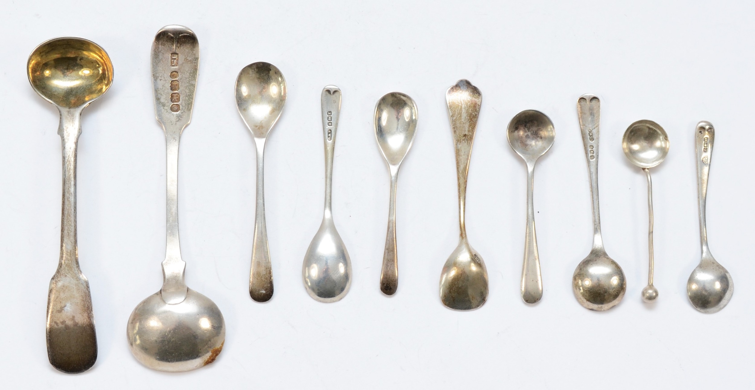 Ten silver condiment spoons to include a Victorian fiddle pattern example, by John Stone, Exeter