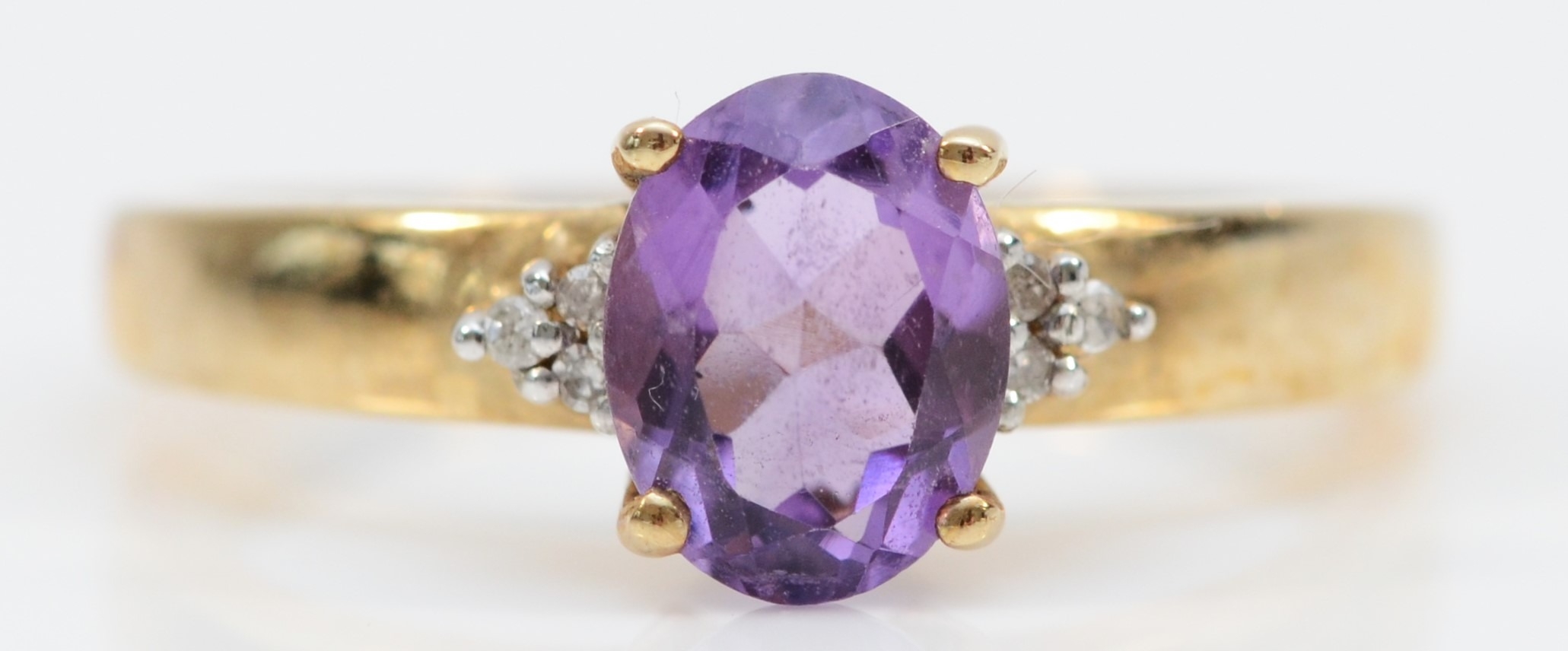 A 9ct gold oval cut amethyst and eight cut diamond dress ring, Q, 2.6gm.