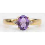 A 9ct gold oval cut amethyst and eight cut diamond dress ring, Q, 2.6gm.