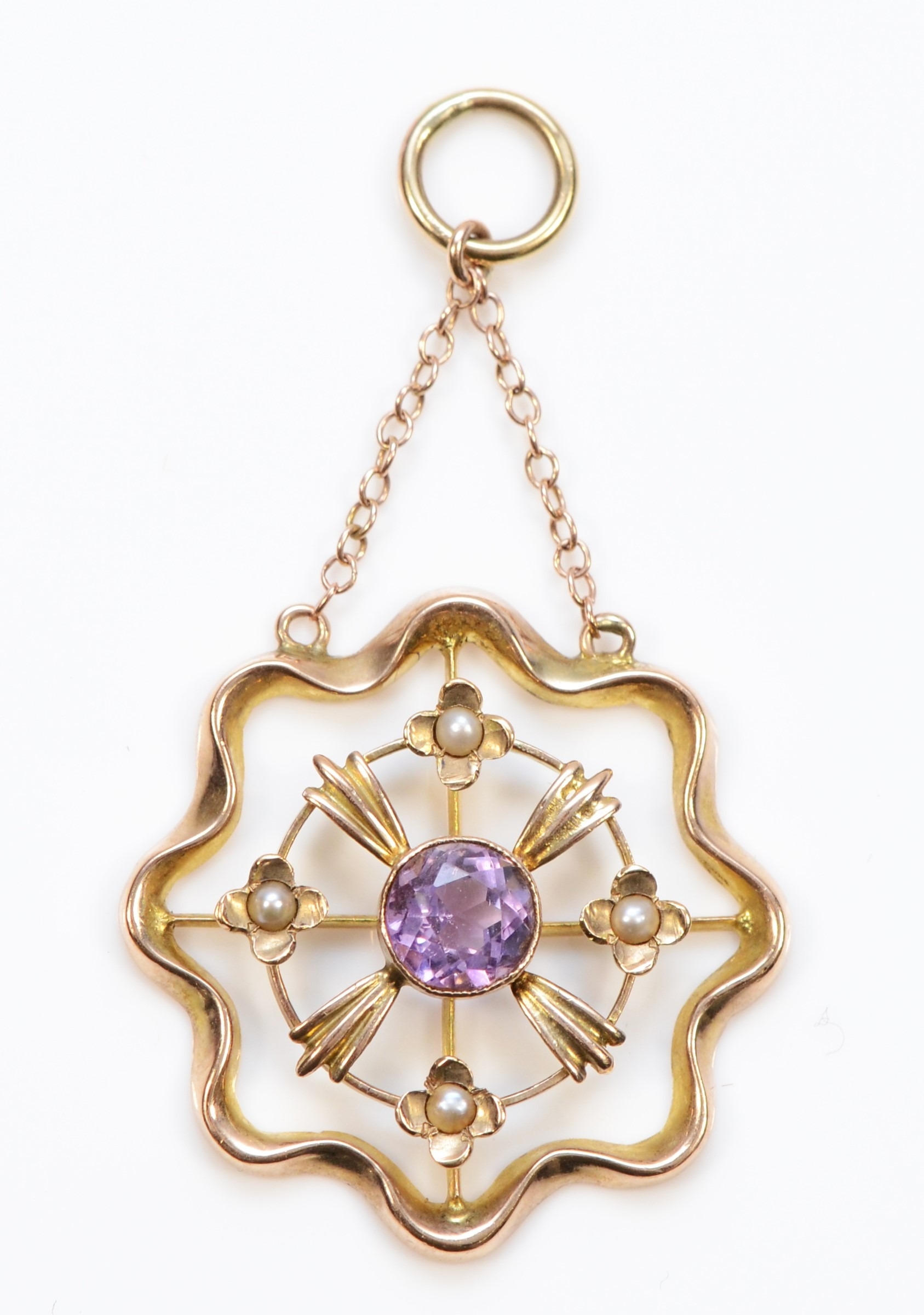 An Edwardian 9ct gold amethyst and seed pearl open work drop pendant, 45 x 25mm, 2gm.