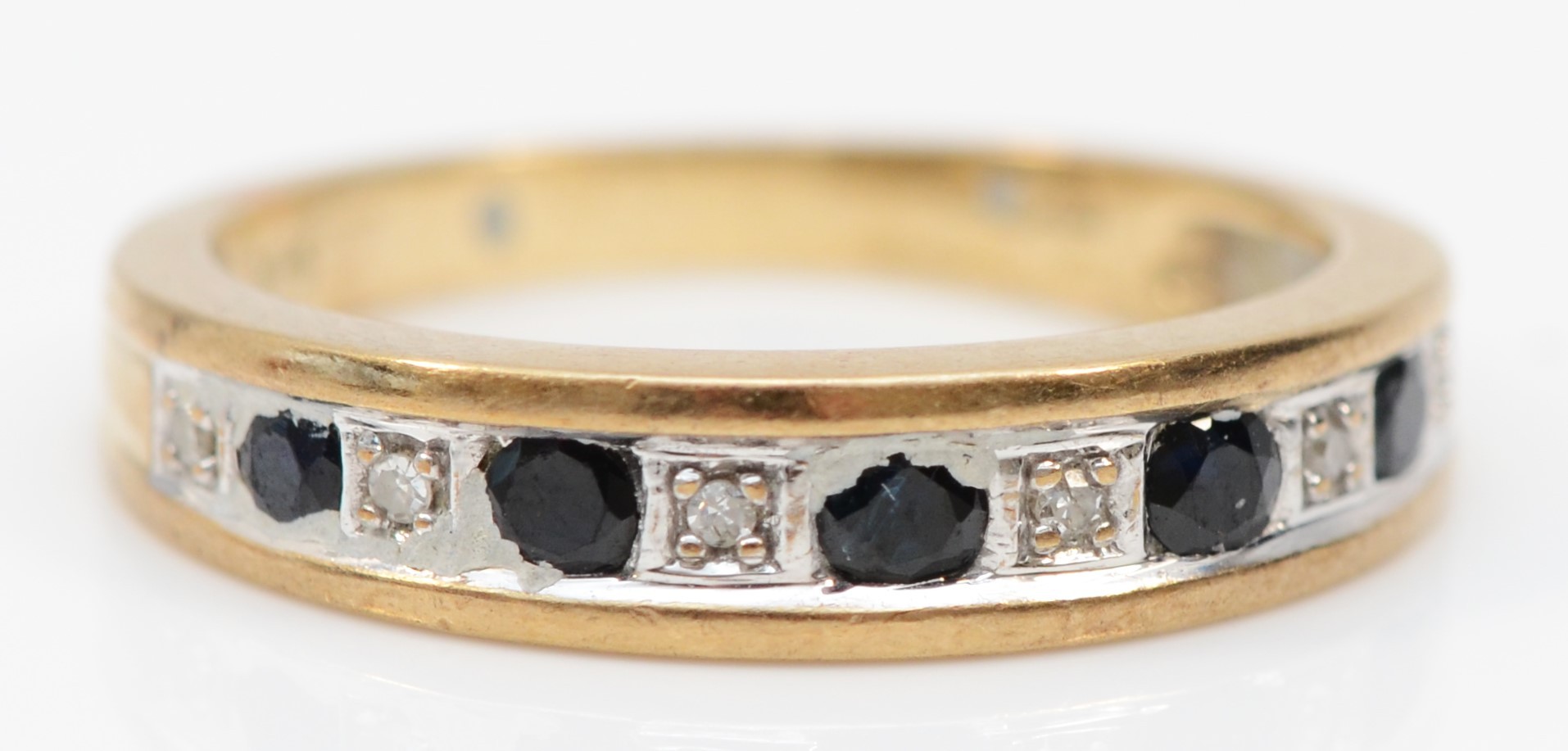 A 9ct gold sapphire and diamond half eternity ring, L, 2.5gm.