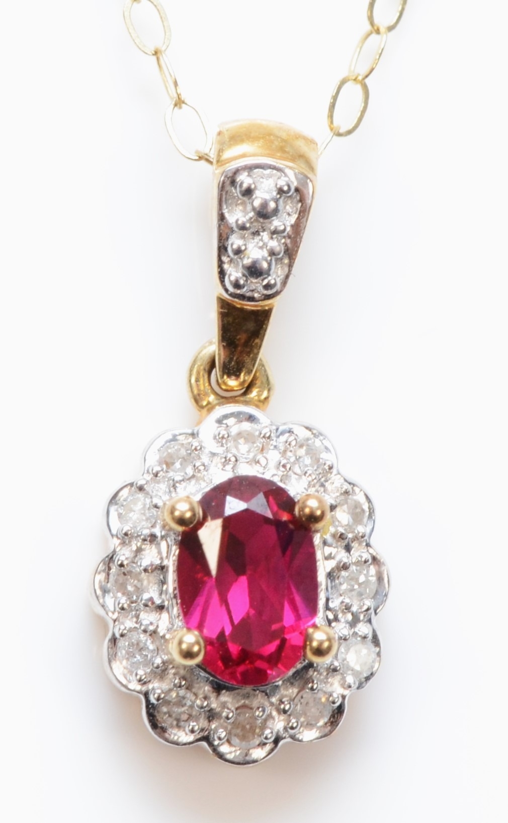 A 9ct gold synthetic ruby and eight cut diamond cluster pendant, on 375 gold chain, 18mm, 2gm.