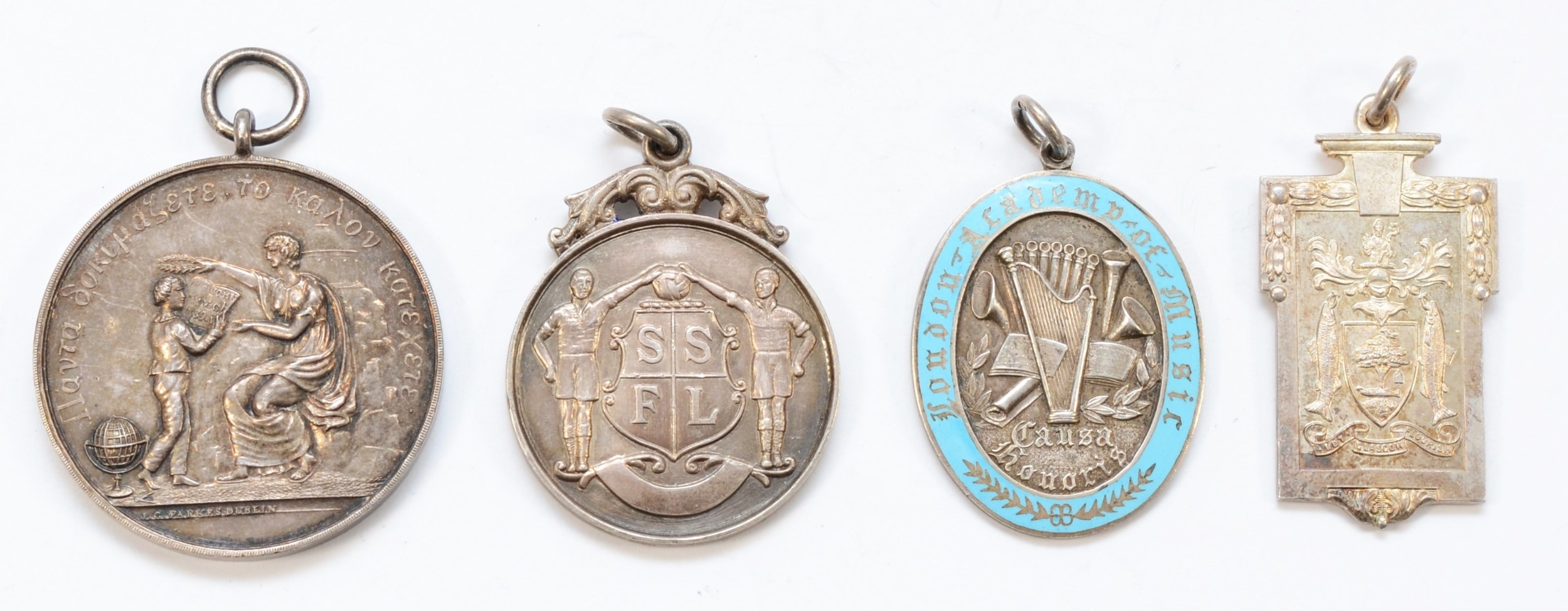 Four silver medallions comprising of, a silver and enamel London Academy of Music Causy Honoris