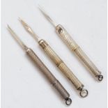 Three vintage silver cased tooth picks,